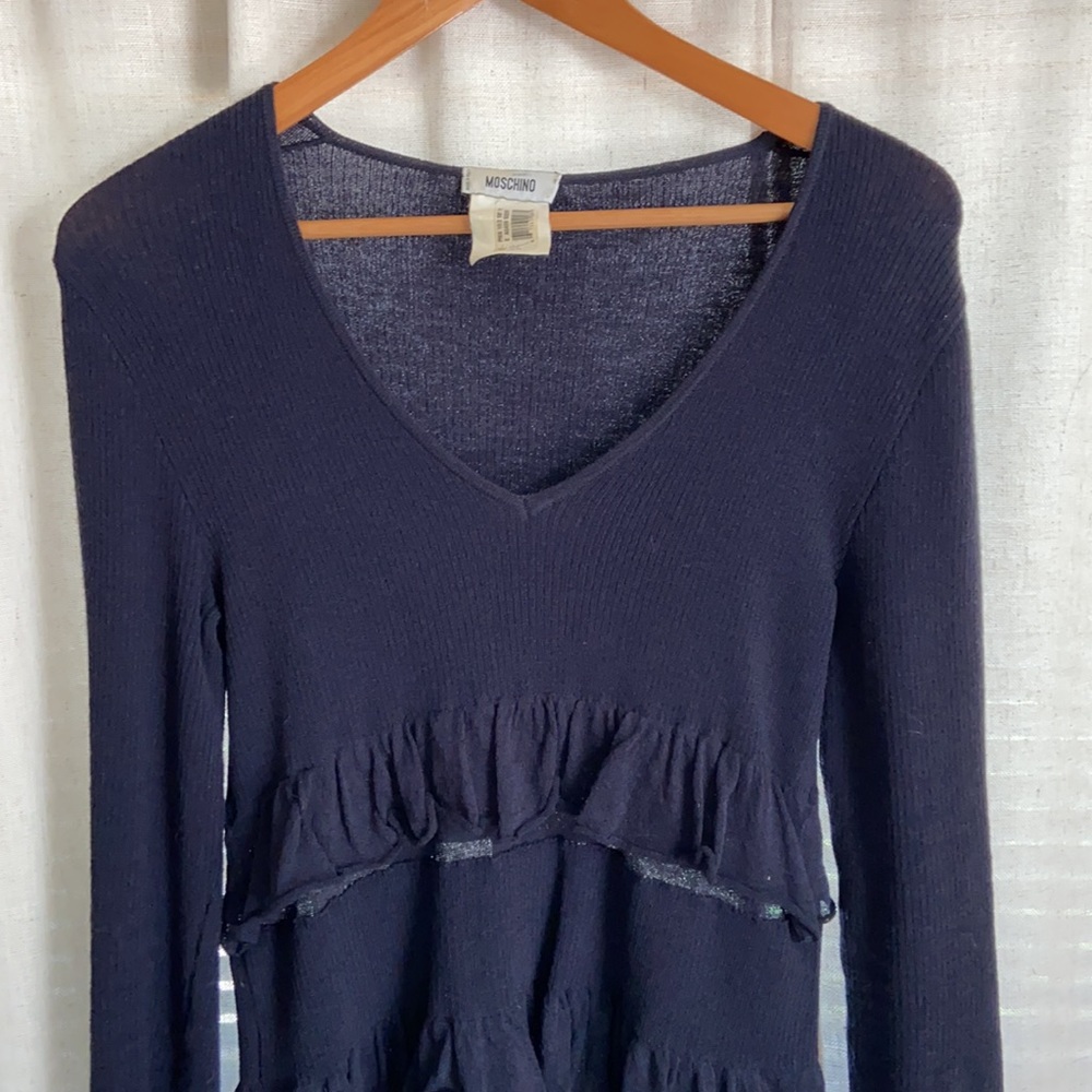 Moschino navy blue virgin wool long sleeve knit dress with sheer ruffle detail.